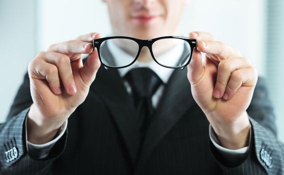 Close up of a businessman holds glasses