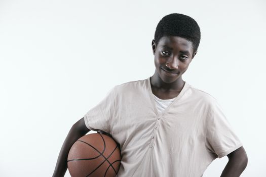 Portrait of african boy with basket ball on white background