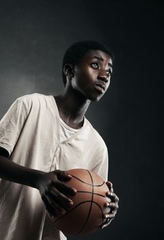 An African boy playing basketball