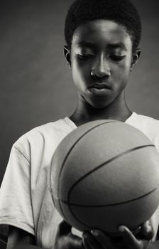 Teenage boy looking the basketball