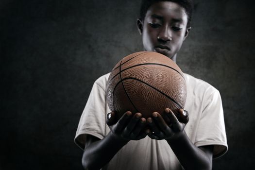 African boy holding a basket ball