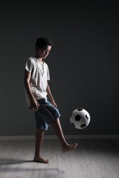 Portrait of young boy playing with a soccerball