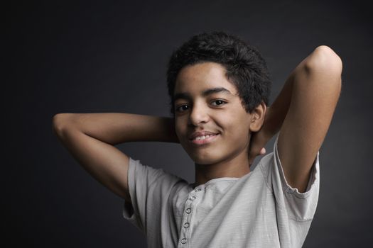 Portrait of cheerful african teenager on black background