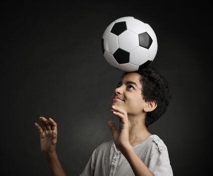 Portrait of young boy playing with a soccerball