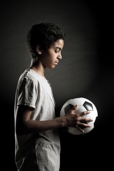 Portrait of young boy with a soccer ball