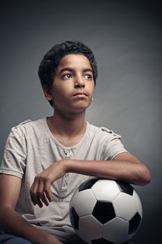 Portrait of young boy with a soccer ball