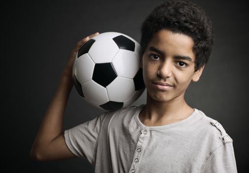 Portrait of young boy with a soccer ball