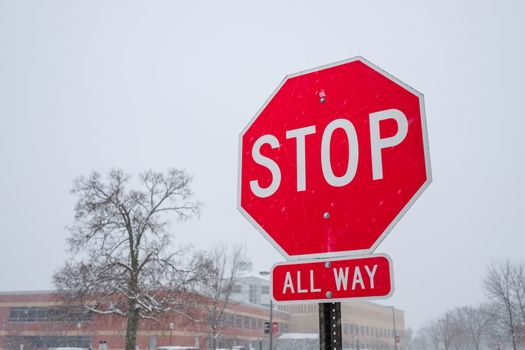 Bright red stop sign standing in a snowy day