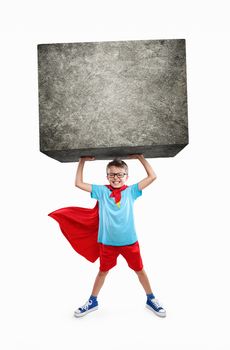 Little boy lifting a large rock with hands