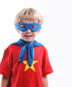 Portrait of a young superhero on white background