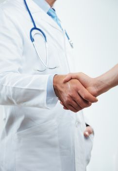Cropped shot of a doctor handshaking with patient