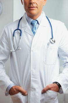 Close up shot of a male doctor standing in his office