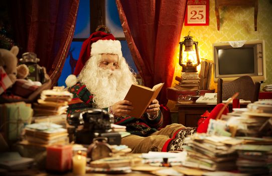 Santa Claus reading a book at home