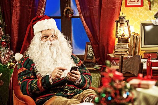 Portrait of Santa Claus using his new smartphone 