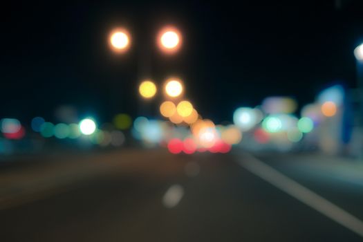 Out of focus lights of a public street during night time
