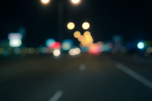 Out of focus lights of a public street during night time