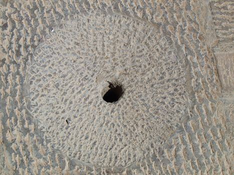 Concrete floor texture with a hole