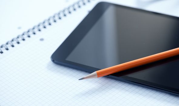 Tablet PC, blank papers and pen on the table.