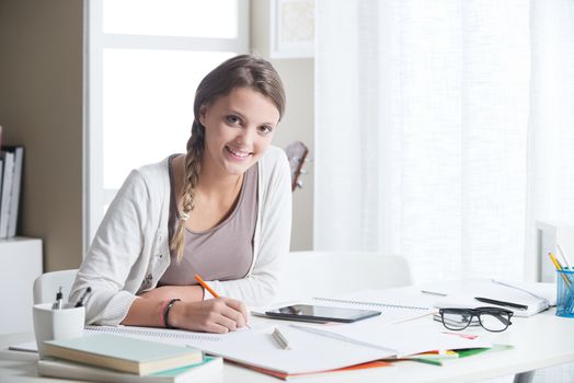 Portrait of a beautiful girl studying at home