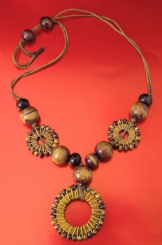 Handmade Wood Collar Necklace on a Colored Background