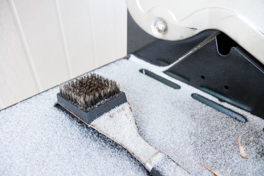 Scrubber for a BBQ covered in snow at the end of the summer season
