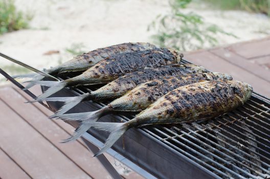 fish grill on grilling sticks , seafood Barbeque