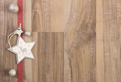 moravian star white with red ribbon on wooden background