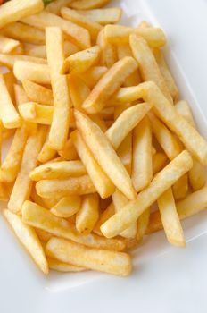 a pile of appetizing french fries on white plate