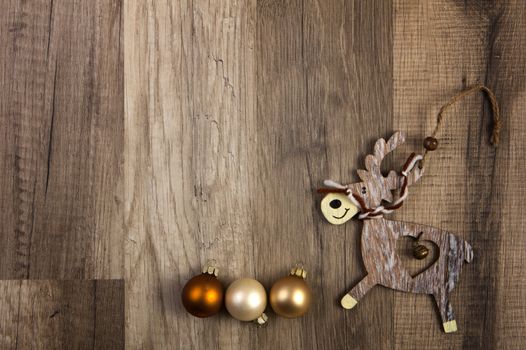 christmas baubles brown, moose on wooden background 