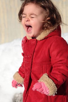 a beautiful caucasian girl playing in the snow