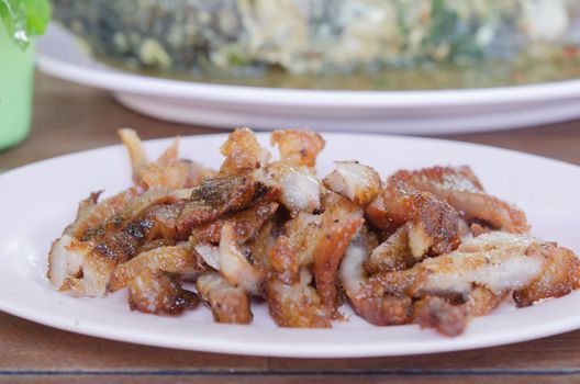 close up slice grilled pork  on pink dish