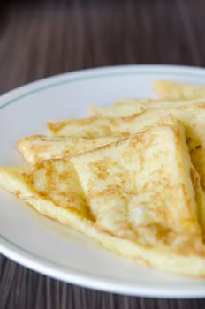 close up slices of french toast on a white dish