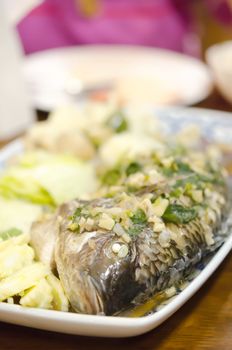 steamed fish with garlic , herbs and vegetable