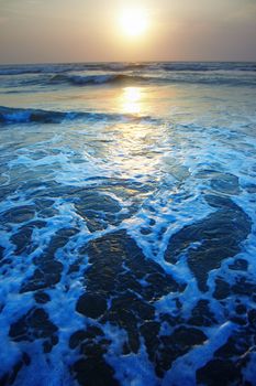 Ocean with waves during sunset. Vivid artistic colors added. Natural darkness