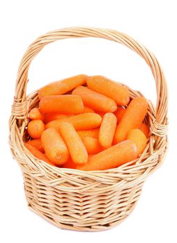 Wicker Basket with Fresh Raw Peeled Baby Carrots isolated on white background