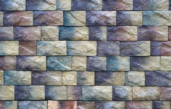 Wall texture of different colored stone blocks                               