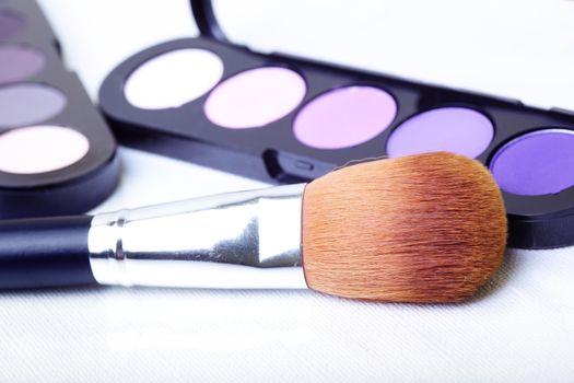 Close-up photo of the makeup set on textured white background