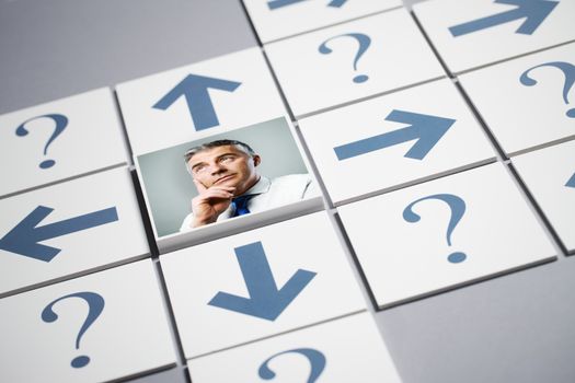 Senior businessman thinking surrounded by question marks and arrows