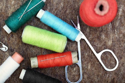 Sewing tools on a woolen fiber. Close-up color photo