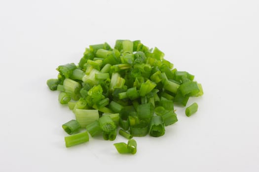 A close up image of chopped spring onions on a white background