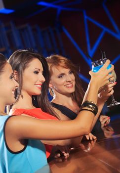 Portrait of joyful friends toasting at party 