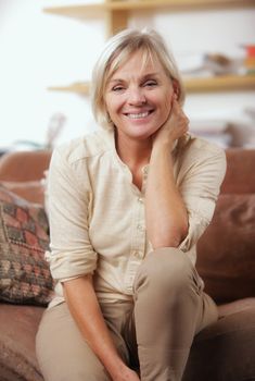 Portrait of a smiling senior woman sitting on couch