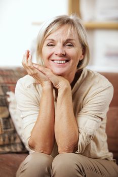 Portrait of a smiling senior woman sitting on couch