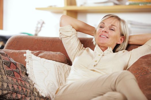 Happy senior woman relaxed on a couch