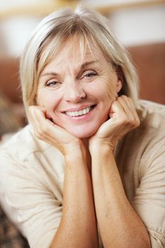 Portrait of a smiling senior woman sitting on couch