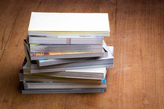 stack of books on brown wooden floor