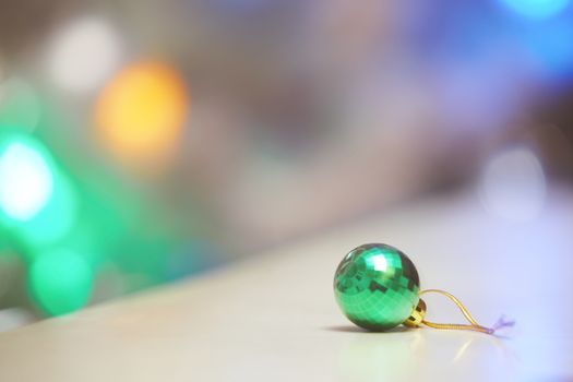 Green Christmas toy and illumination on a background. Close-up view