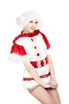 Smiling lady in the warm furry Christmas dress and cap on a white background