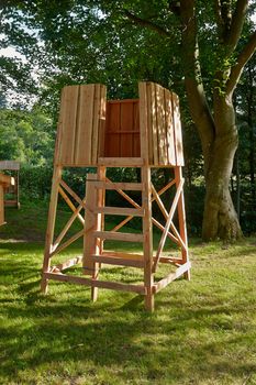 Hunter's box shooting stand in the forest - hunting image                              