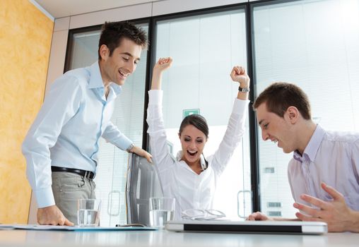 An excited young business team celebrating their success